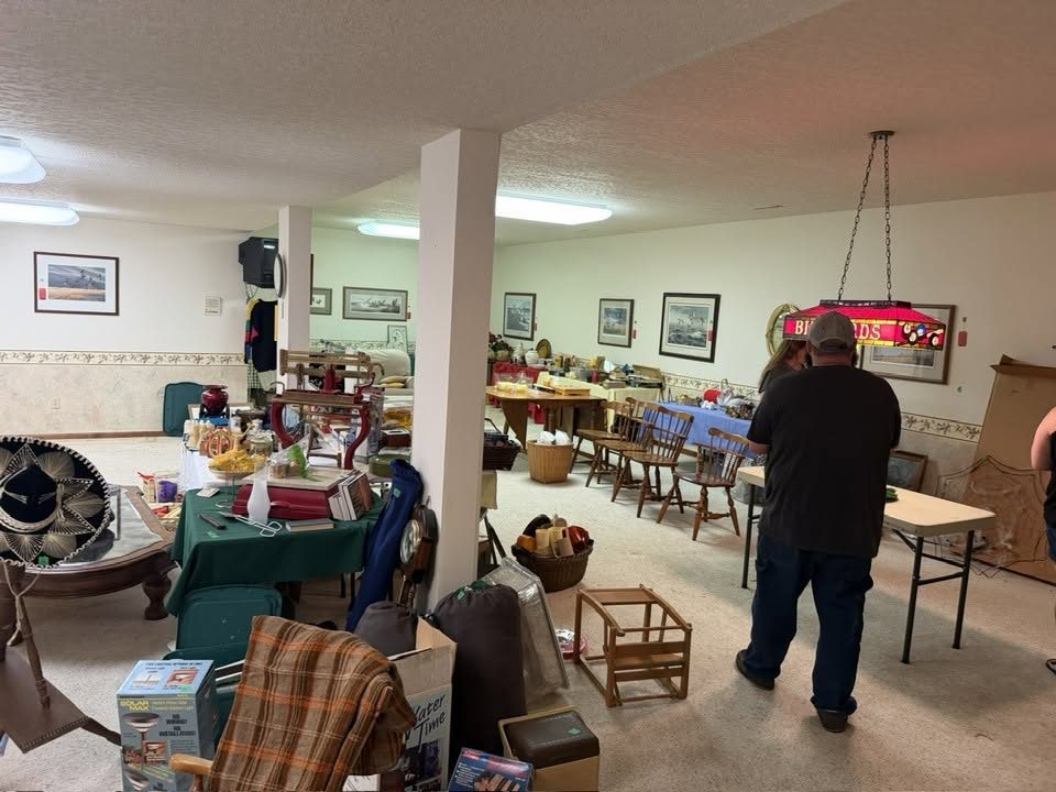 Shoppers browsing tables of household items at a Simple Clean Out estate sale