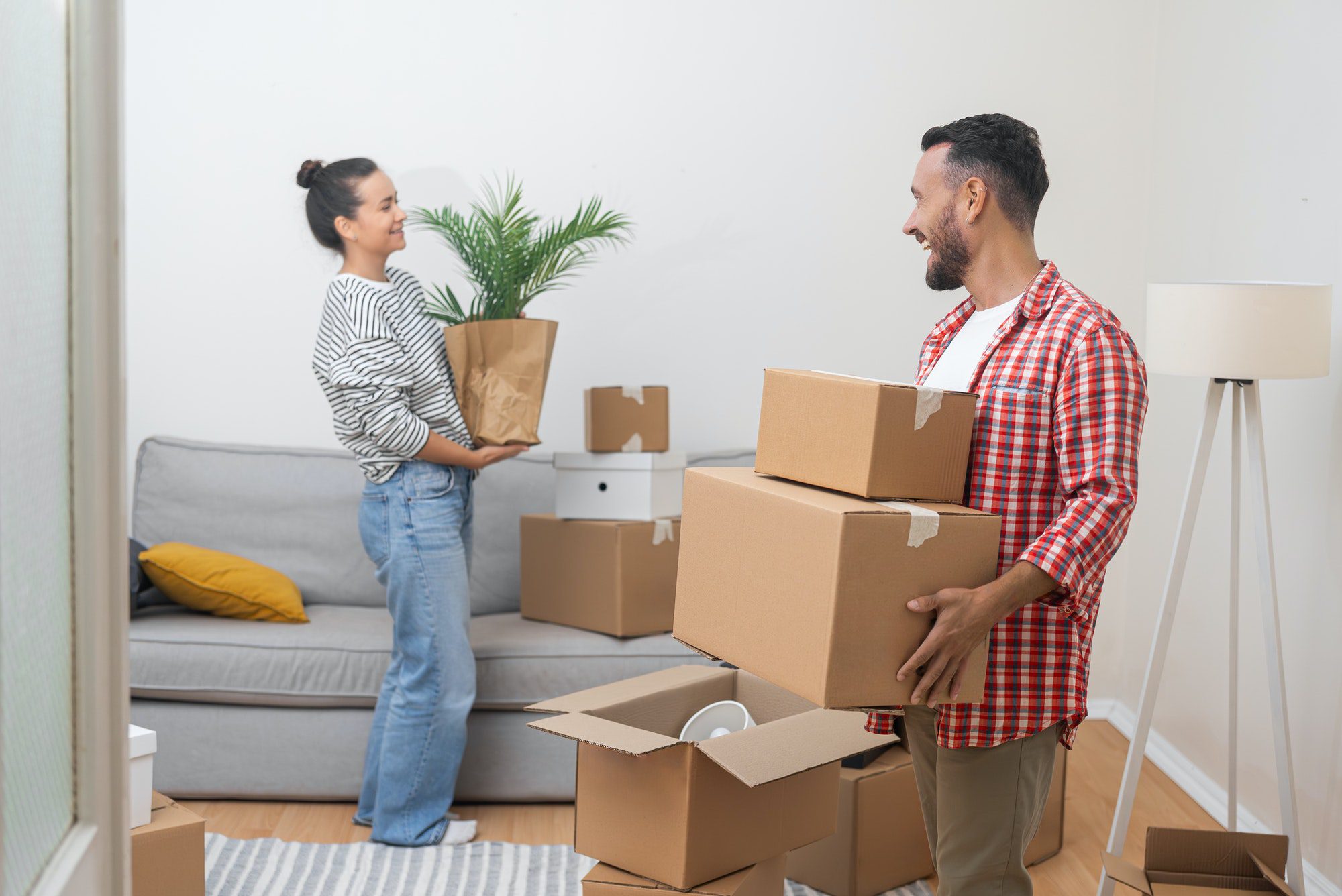 Clients smiling while packing boxes during a stress-free move