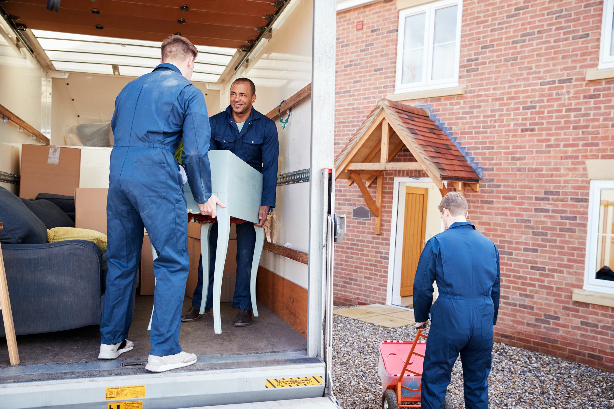 Simple Clean Out team removing furniture and boxes during a Des Moines property cleanout