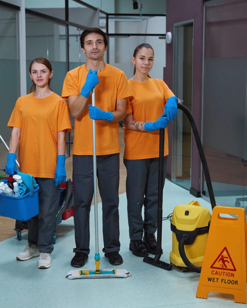 Young workers cleaning property